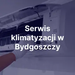 Instalator w rękawiczce naprawia klimatyzację w Bydgoszczy.
