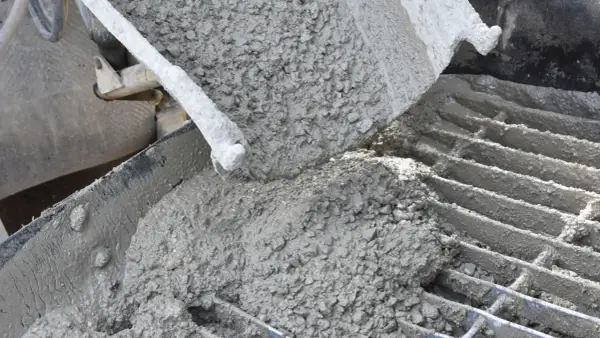 Świeży beton wylewany z betoniarki. Idealny jaki beton na ogrzewanie podłogowe, zapewniający równomierne rozprowadzenie ciepła.